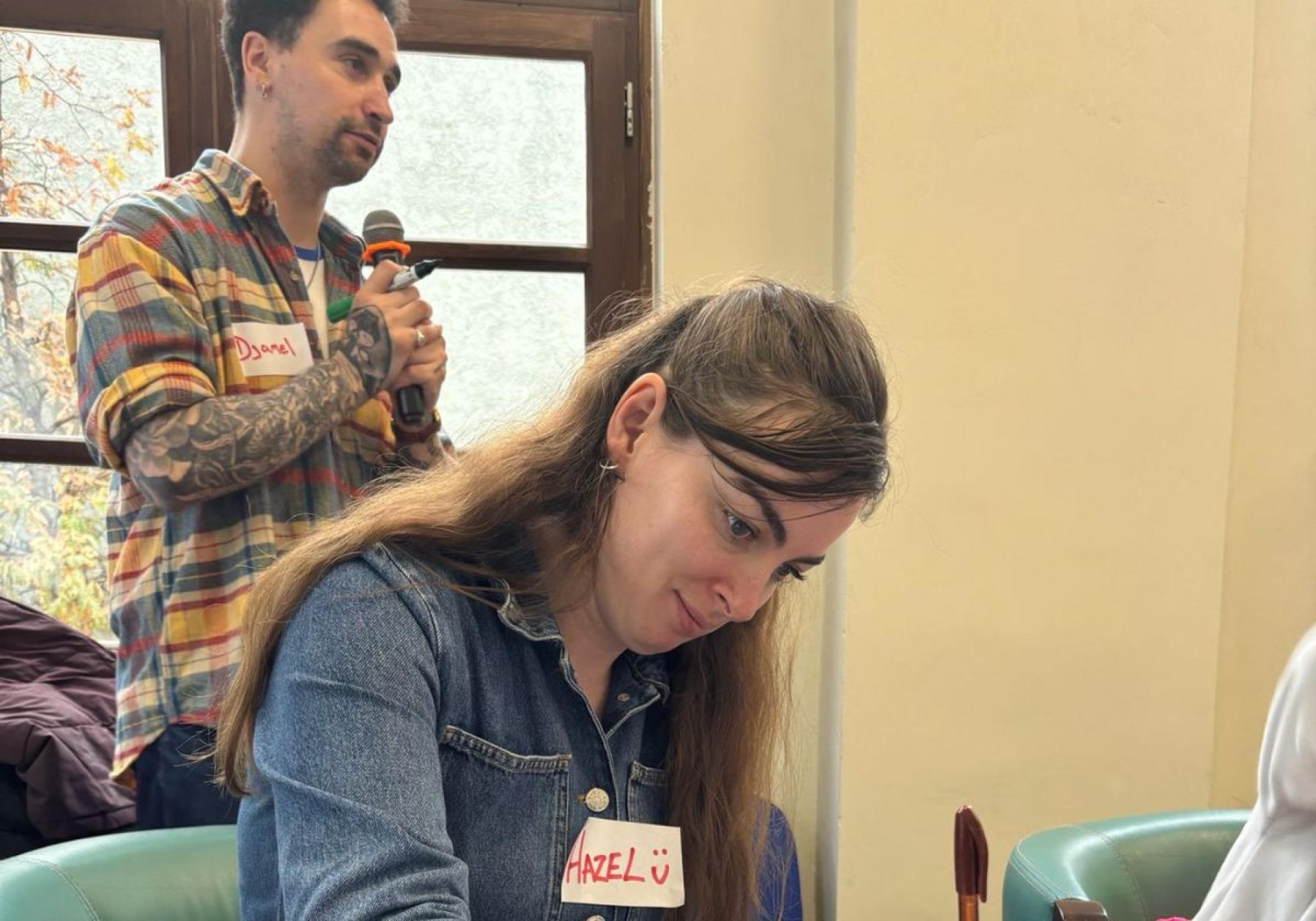 Djamel White and Hazel Hogan participating in creative writing workshops with young writers
