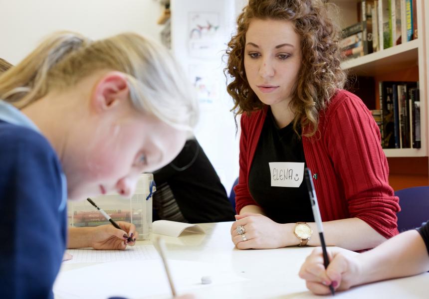Volunteer mentor working with students