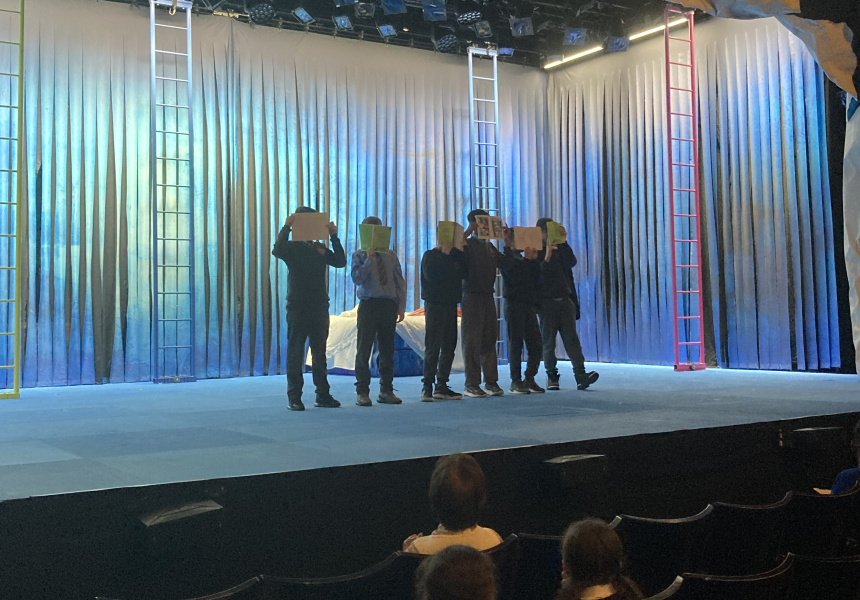 Students on stage showing their work