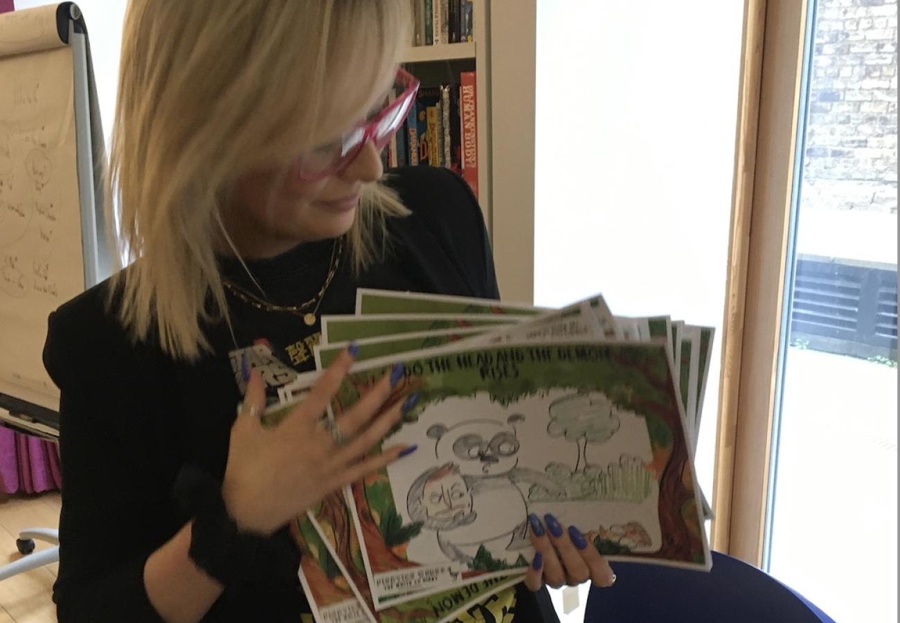 Teacher holding the school's story