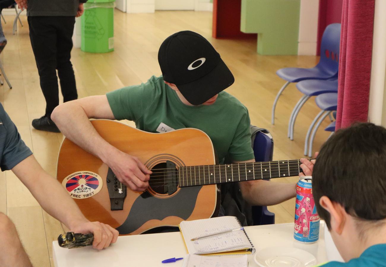Young person playing guitar